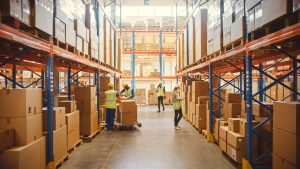Warehouse workers managing inventory operations affected by mobile scanning failures