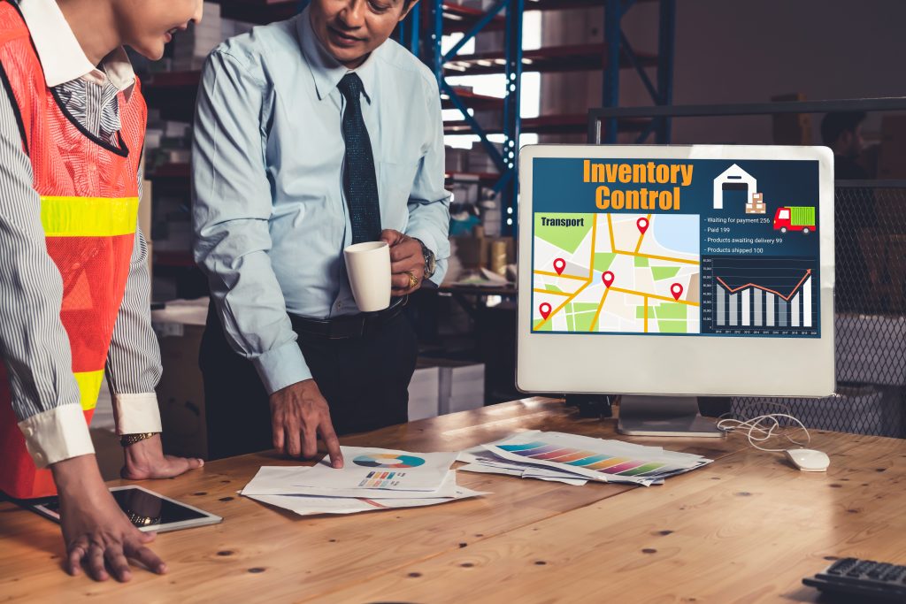 Warehouse operations team reviewing a real-time inventory control dashboard