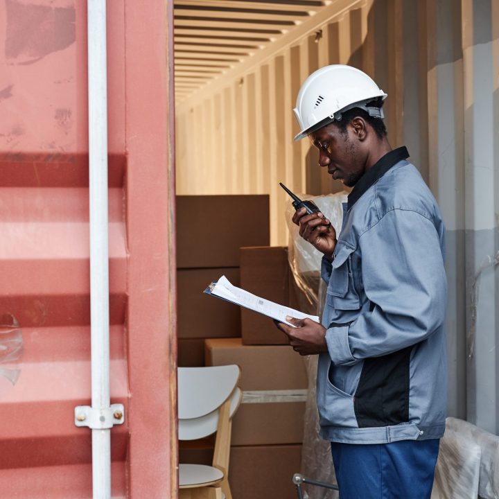 Warehouse employee checking shipments while facing mobile scanning issues in operations