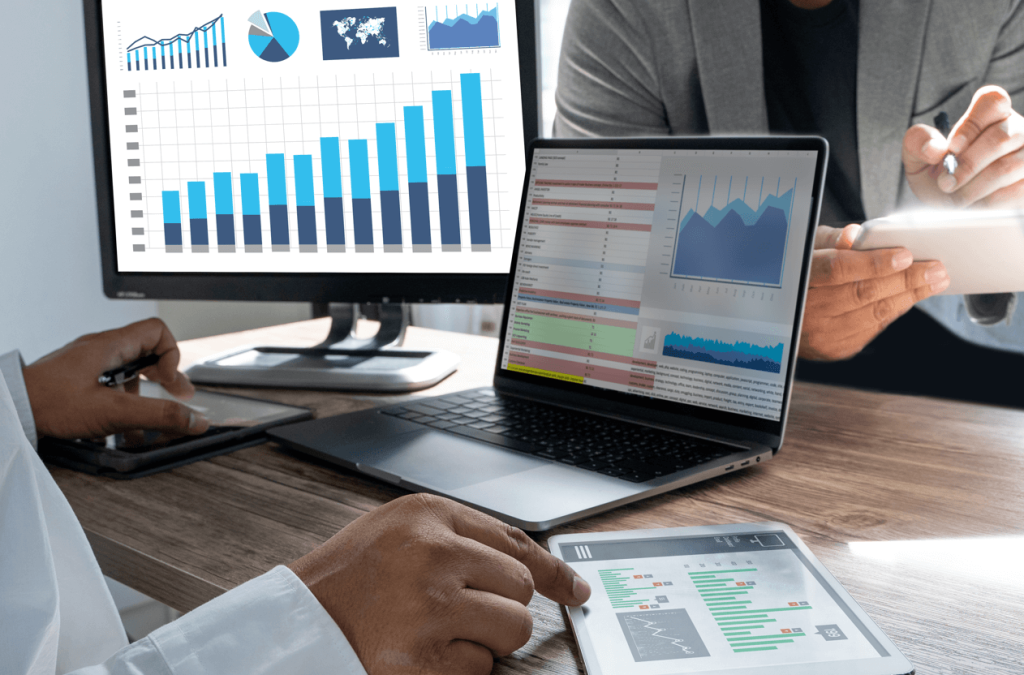 Analysts reviewing financial charts and enterprise software dashboards to quantify the revenue leaks caused by work order cost capture failures.