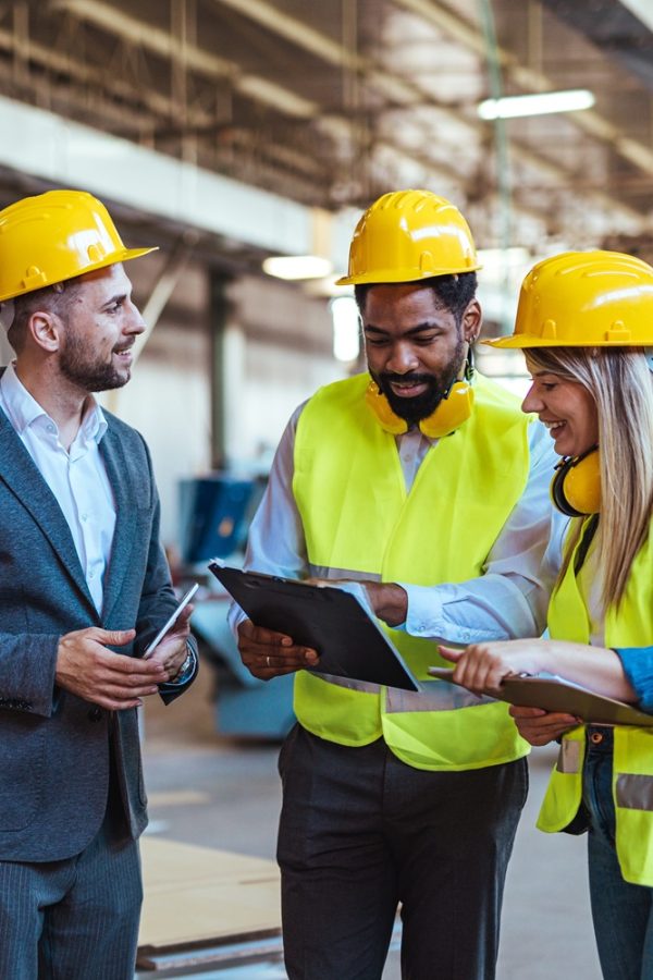 Business-engaged,Professionals,Collaborating,In,A,Construction,Site,,Reviewing,Plans,And